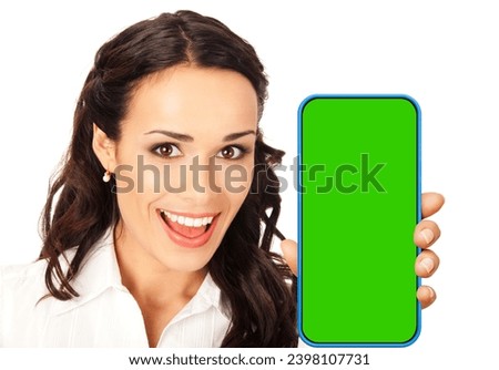 Portrait image - happy smiling young woman wear confident cloth, hold show smartphone cell phone mobile with green chroma key mockup screen, isolated over white background. App application ad.