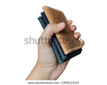 a woman's hand is holding leather wallet, photo taken with white solated backgrund, easy to use and editable for project, design, banner, adversting, presentation and many more