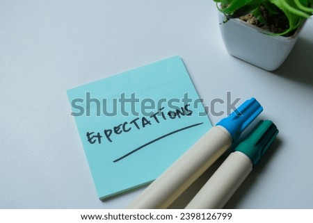 Concept of Expectations write on sticky notes isolated on white background.
