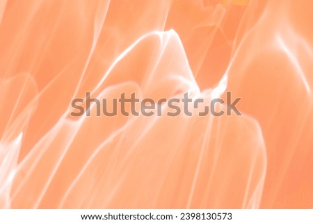 Wavy lines of light as Abstract blurred background peach colored, natural glare from lights, trend color year 2024 peach fuzz, gradient color, blur texture as Glittering aesthetic textured pattern Royalty-Free Stock Photo #2398130573