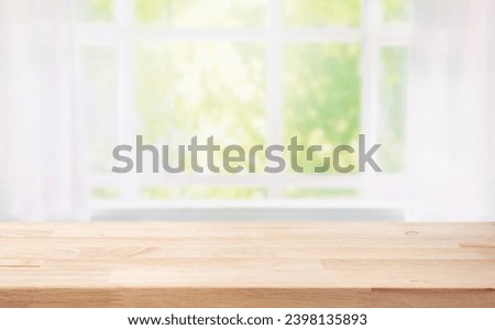 Selective focus.Wood table counter on blur curtain window in morning background.For montage product display or design key visual