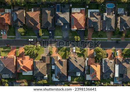 Top down aerial view of a neighbourhood street lined with upmarket houses in outer suburban Sydney, Australia. Royalty-Free Stock Photo #2398136641