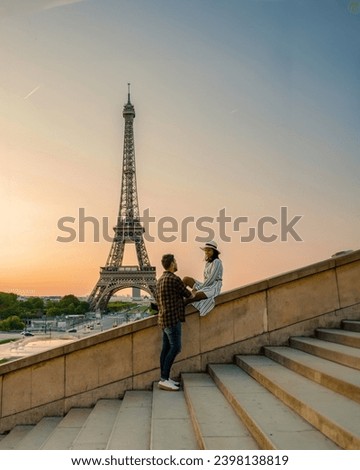 Young couple by Eiffel Tower at Sunrise Paris Eifel Towe, man woman in love valentine concept in Paris the city of love. Men and women visiting the Eiffel Tower honeymoon trip Royalty-Free Stock Photo #2398138819