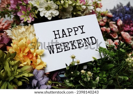 Happy Weekend text message on paper card with beautiful flowers decoration