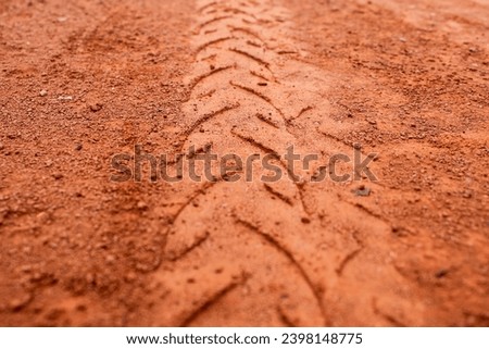 Motorcycle tire treads on red soil