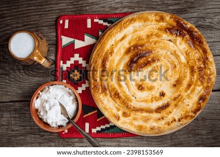 Traditional Bosnian and Turkish meal made from rolled pastry filled with spinach. In Turkey it is called Borek with cheese. In Bosnia this dish is called Pita Sirnica. Made from phyllo pastry. Royalty-Free Stock Photo #2398153569