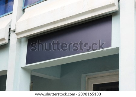 Clear signboard banner on a storefront mock up template for business logo and branding. Blank black restaurant or shop signboard copy space mockup.