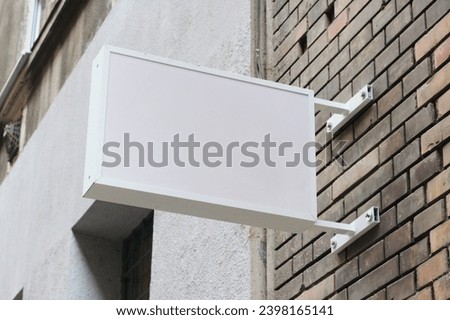 Street storefront shop, cafe, restaurant mounted signboard mock up design template. Blank white store sign design mockup.