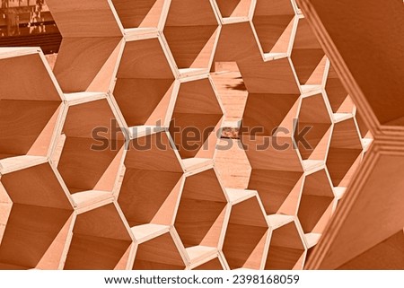 Peach fuzz is color of year 2024. Geometric honeycombs toned in fashion blended pink-orange trend-setting colour of year Peach Fuzz