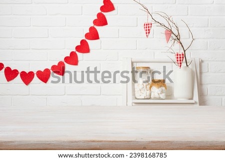 Wooden table top over white brick wall in kitchen decorated for Valentines day celebration