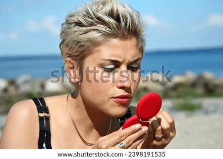 Cute blond girl with makeup in the summer in Denmark