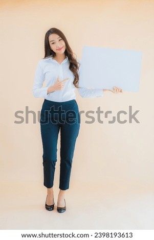 Portrait beautiful young asian business woman show white empty billboard banner on isolated color background