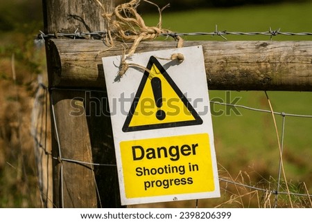 Sign: Danger shooting in progress, seen near Ystradfellte in Powys, Wales, UK