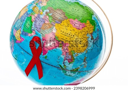 Red ribbon on the globe.