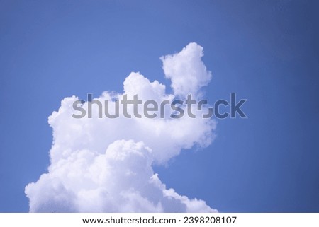 Sky background with white clouds resembling an elephant's trunk, clouds resembling an elephant-shaped animal. Royalty-Free Stock Photo #2398208107