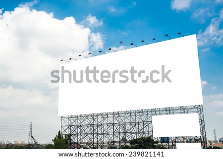 Blank billboard with blue sky in city.
