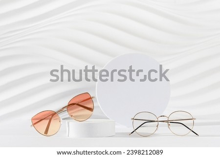 Sunglasses and glasses sale concept. Trendy sunglasses on podiums on a white background. Trendy Fashion summer accessories. Copy space. Promotion, sale. Optic store discount poster. Minimal Royalty-Free Stock Photo #2398212089