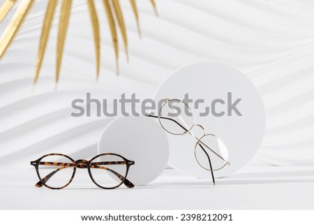 Two pairs of eyeglass frames on white background. Minimalism, eyewear fashion concept. Trendy eyeglasses still life in minimal style. Optic store discount, sale, promotion. Copy space Royalty-Free Stock Photo #2398212091