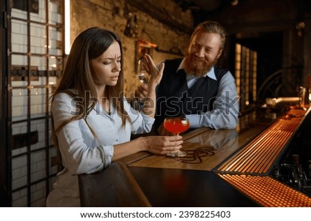 Pick up in bar, focus on woman stopping attempt to start conversation Royalty-Free Stock Photo #2398225403