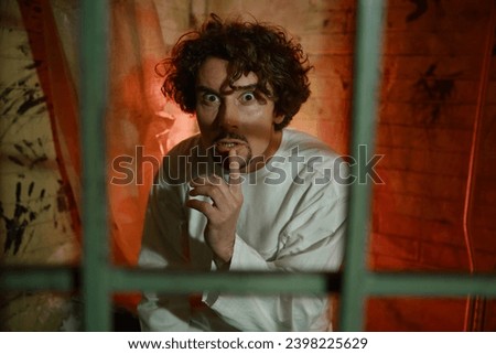 Frightened craze man psychiatric hospital patient looking at camera Royalty-Free Stock Photo #2398225629