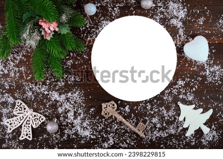New Year's card on a wooden background.Christmas balls are toys.the glove of Santa Claus.santa claus.Snowflake.Birdie.A branch of the Christmas tree.festive background, place for text.bathhouse