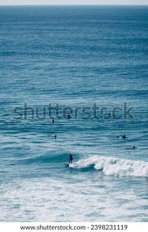 Beautiful picture of surfing in the south of Portugal. With waves and sunshine, on a perfect summer holiday day.          