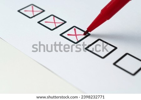 Cross on the checklist sheet Royalty-Free Stock Photo #2398232771