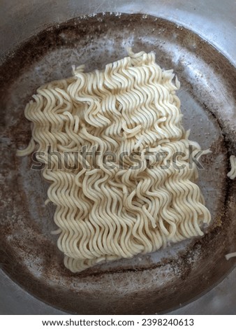 Instant noodles being boiled for lunch