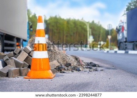 Road orange traffic cone on road, road works Royalty-Free Stock Photo #2398244877