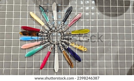 Bright abstract picture, beautiful mother of pearl nacreous handles on a ring, arranged in a circle on small mazaik tiles