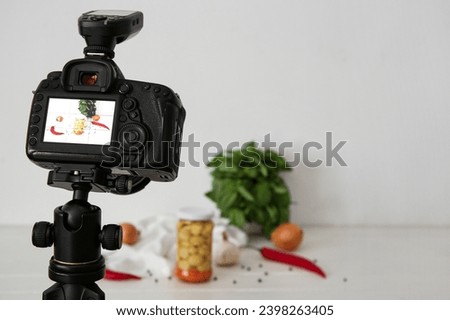 Fresh vegetables on display of professional photo camera in studio