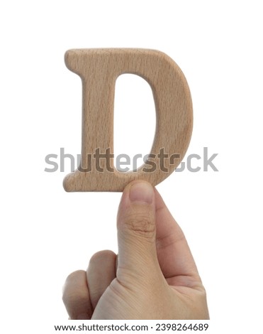 Hand holding wooden letter D