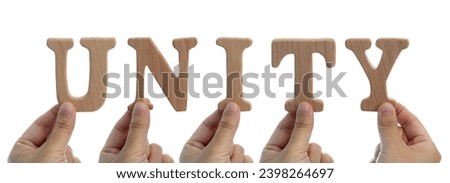 Hands holding wooden word unity