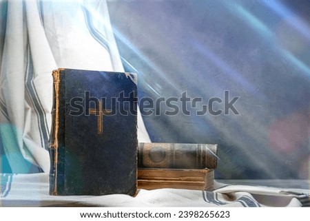 Old book Holy Bible. Cross on a dark cover. Sacred scripture, that contains the word of God. Ancient edition, vintage worn paper. Copy space Royalty-Free Stock Photo #2398265623