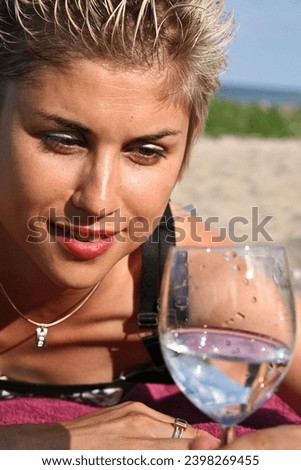 Cute blond girl playing with water in the summer in Denmark