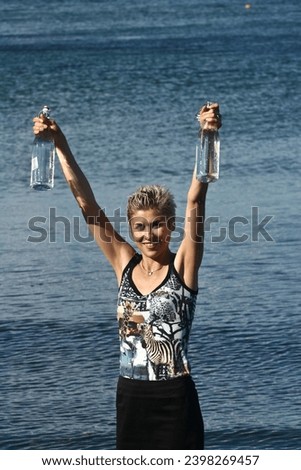 Cute blond girl playing with water in the summer in Denmark