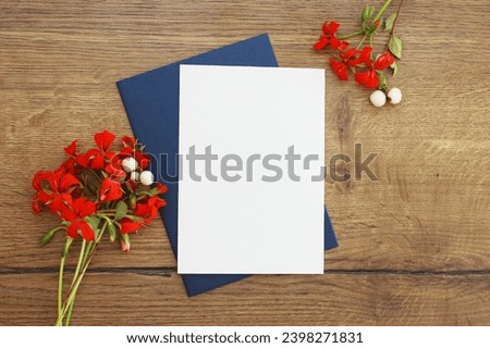 Wedding card greeting and invitation postcard with envelope mock up, vertical flat composition with floral decoration and wood background mock up template with copy space.
