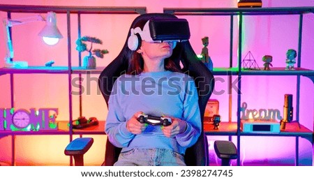 Gamers play in a room with RGB lighting. Game with vr glasses. Joystick game. Handsome guy and girl play computer games. Virtual reality glasses.