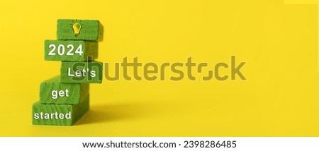 Green blocks with figure 2024 and text LET'S GET STARTED on yellow background Royalty-Free Stock Photo #2398286485