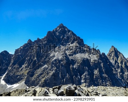 Scenic view from mountain summit Viso Mozzo of Monte Viso (Monviso) in Cottian Alps, Cuneo, Piemonte, Italy, Europe. Hiking trail from Pian del Re. Massive rock walls and ridges in majestic landscape Royalty-Free Stock Photo #2398293901