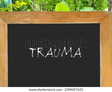 Black chalkboard with handwriting text Trauma -  person's emotional response to a distressing experience,  lasting emotional response results from intensely stressful  events Royalty-Free Stock Photo #2398297623