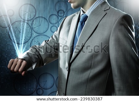 Close up of businessman looking at watch at his wrist