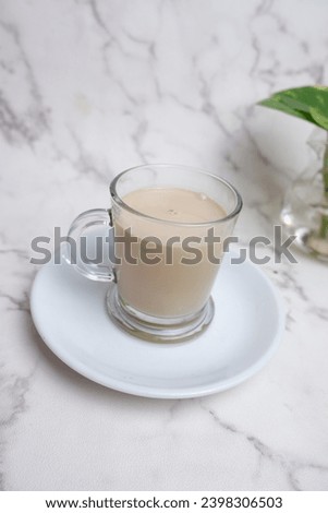A picture of "kopi susu" or milk coffee on white background.