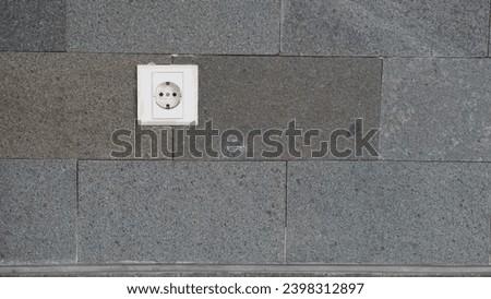 Picture of an electrical plugs with a grey-coloured wall background