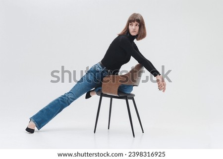 Women model in front of white background in studio. A girl with a short haircut, a professional model. Fashion, catwalk.
