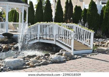 White Footbridge Decorated with Foliage	