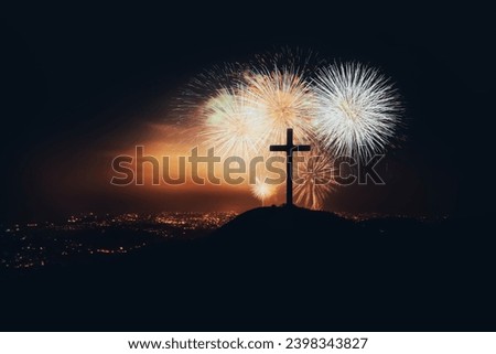 Christmas fireworks festival and fireworks to celebrate the holiday season and New Year, New Year's night cityscape and church cross silhouette
