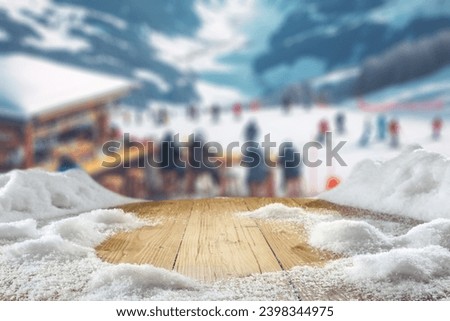 Wooden old desk cover of snow and frost. Winter time in Alps. Blurred background of mountains. Empty space for your decoration. Christmas time.  Royalty-Free Stock Photo #2398344975