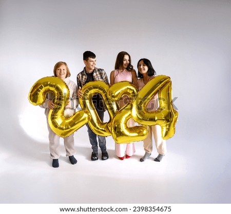 A family cheerfully decorates the house for the winter holidays, holding balloons in the shape of the numbers 2024, indicating the upcoming New Year.