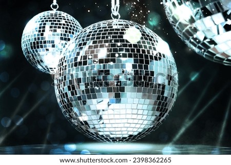 Shiny disco balls on dark background with blurred lights, bokeh effect